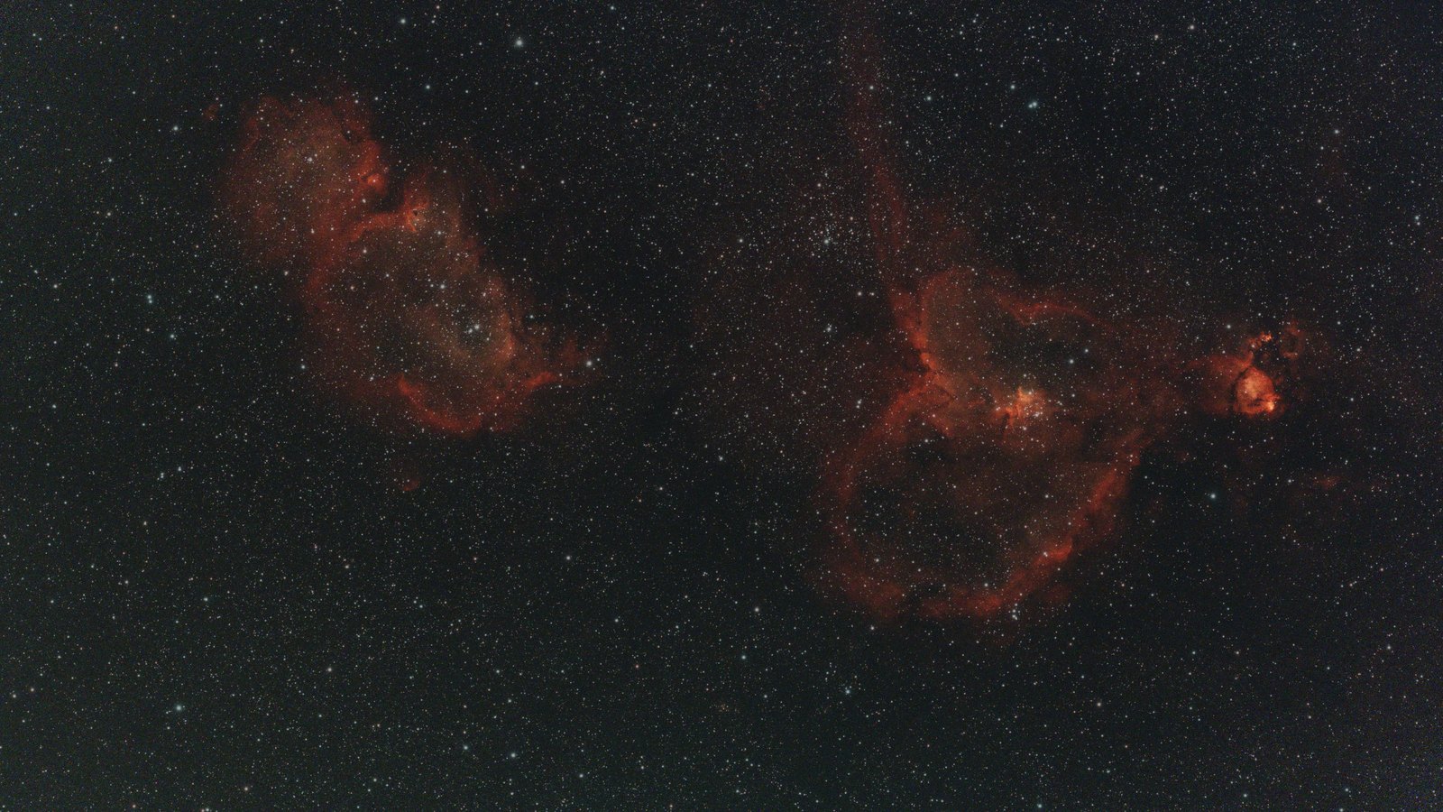The Heart and Soul nebulae side by side in red