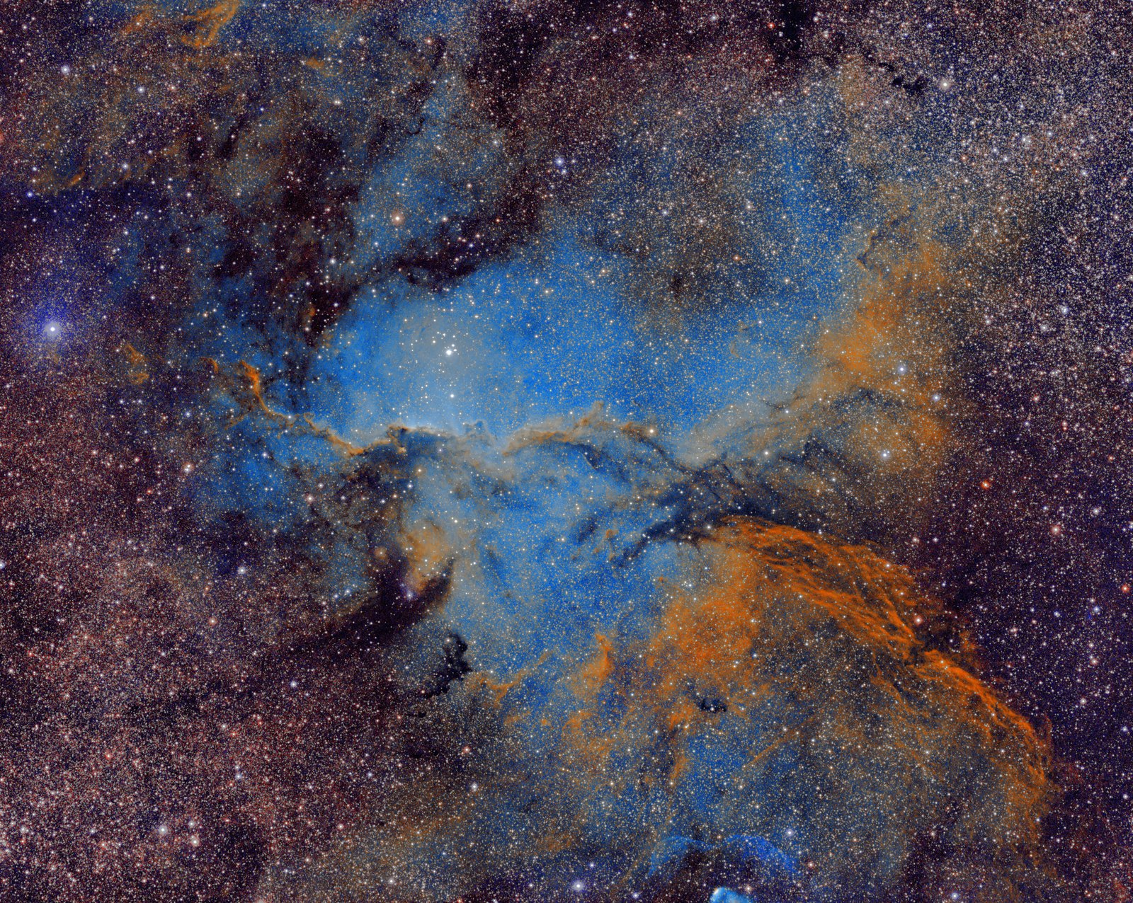 NGC 6188 in the Hubble palette: gold and blue clouds with dark dust